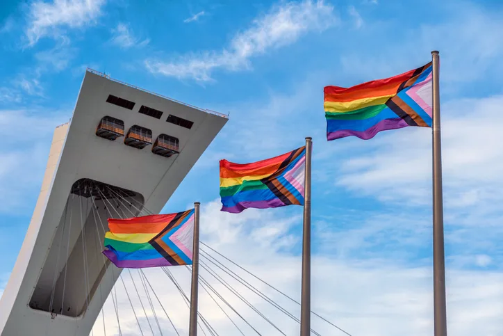 Montreal, CA - 4 August 2022: LGBTQ Progress Pride Rainbow Flags in front of Montreal Olympic Stadium